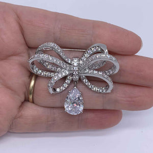 silver bow brooch crystal