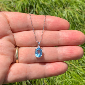 sky blue topaz necklace in hand