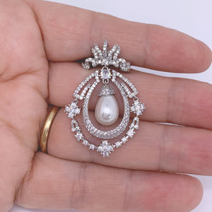 silver pearl brooch hand