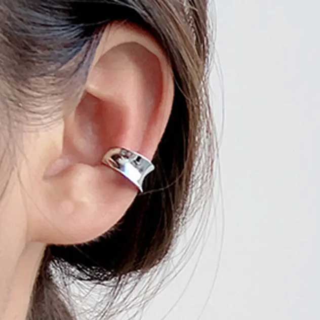 silver ear cuff on ear