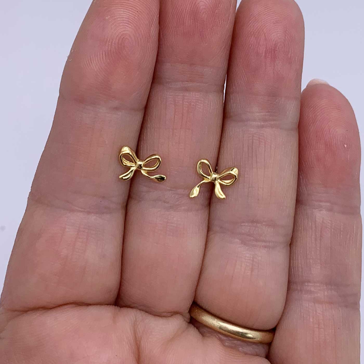 gold blow stud earrings jewellery