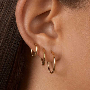 gold hoop earrings three in ear