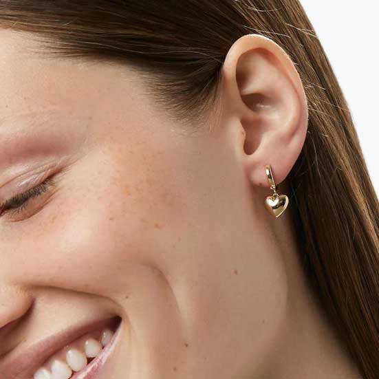 gold frenelle huggie heart earrings