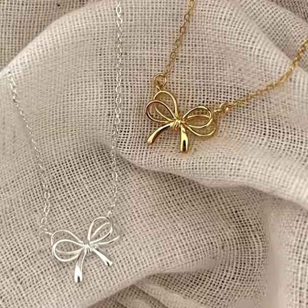 gold bow necklace and silver