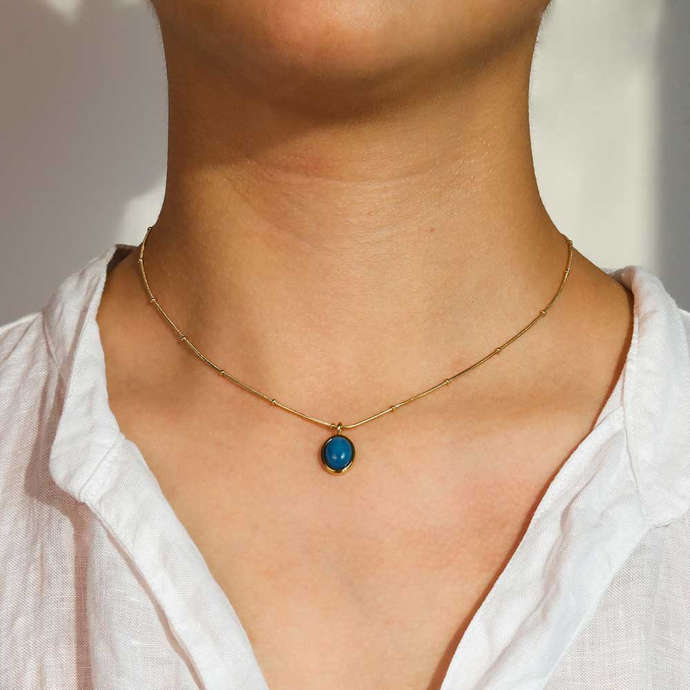 Blue gold Pendant necklace on neck