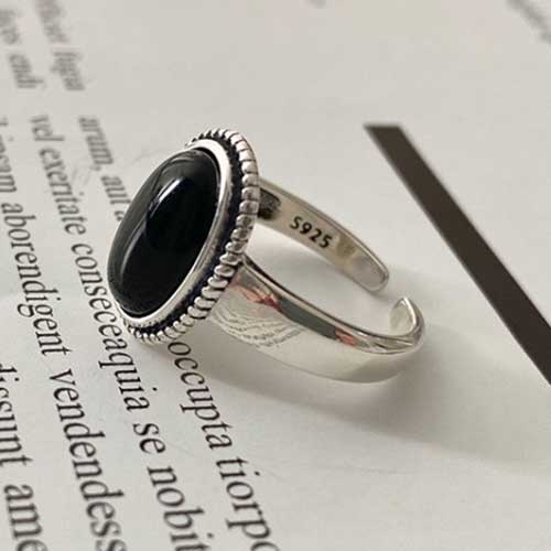 black onyx adjustable silver ring on paper