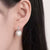 white pearl earrings