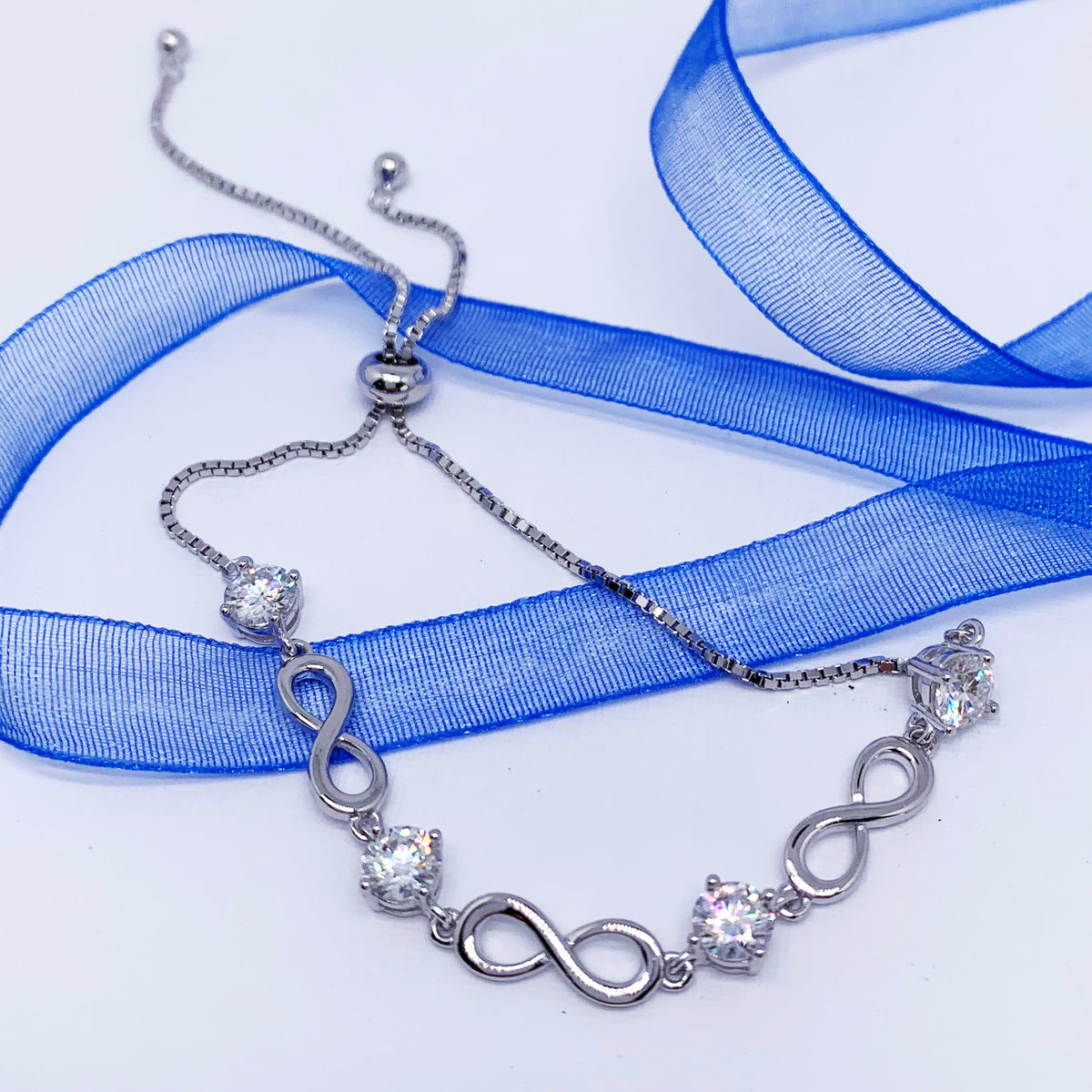 silver adjustable moissanite bracelet blue ribbon