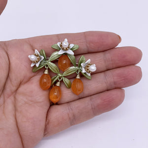 orange blossom brooch hand