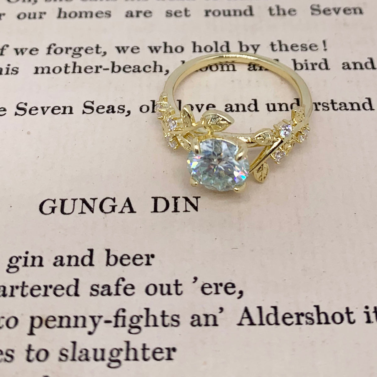 gold moissanite dress ring with leaf design by frenelle jewellery