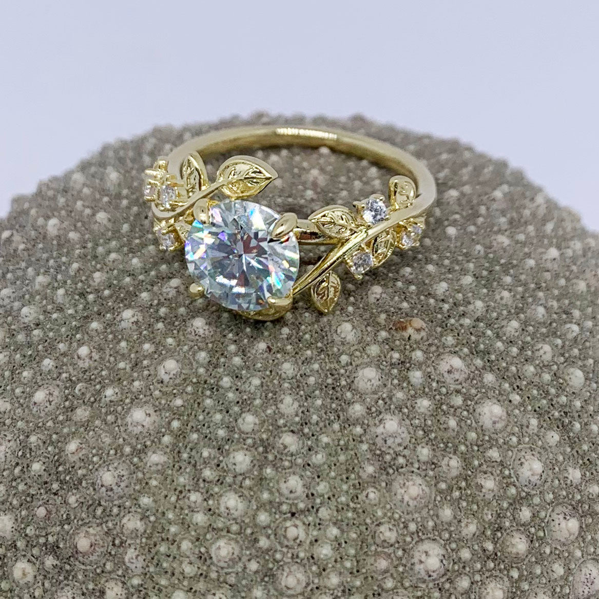 gold moissanite dress ring with leaf design by frenelle jewellery