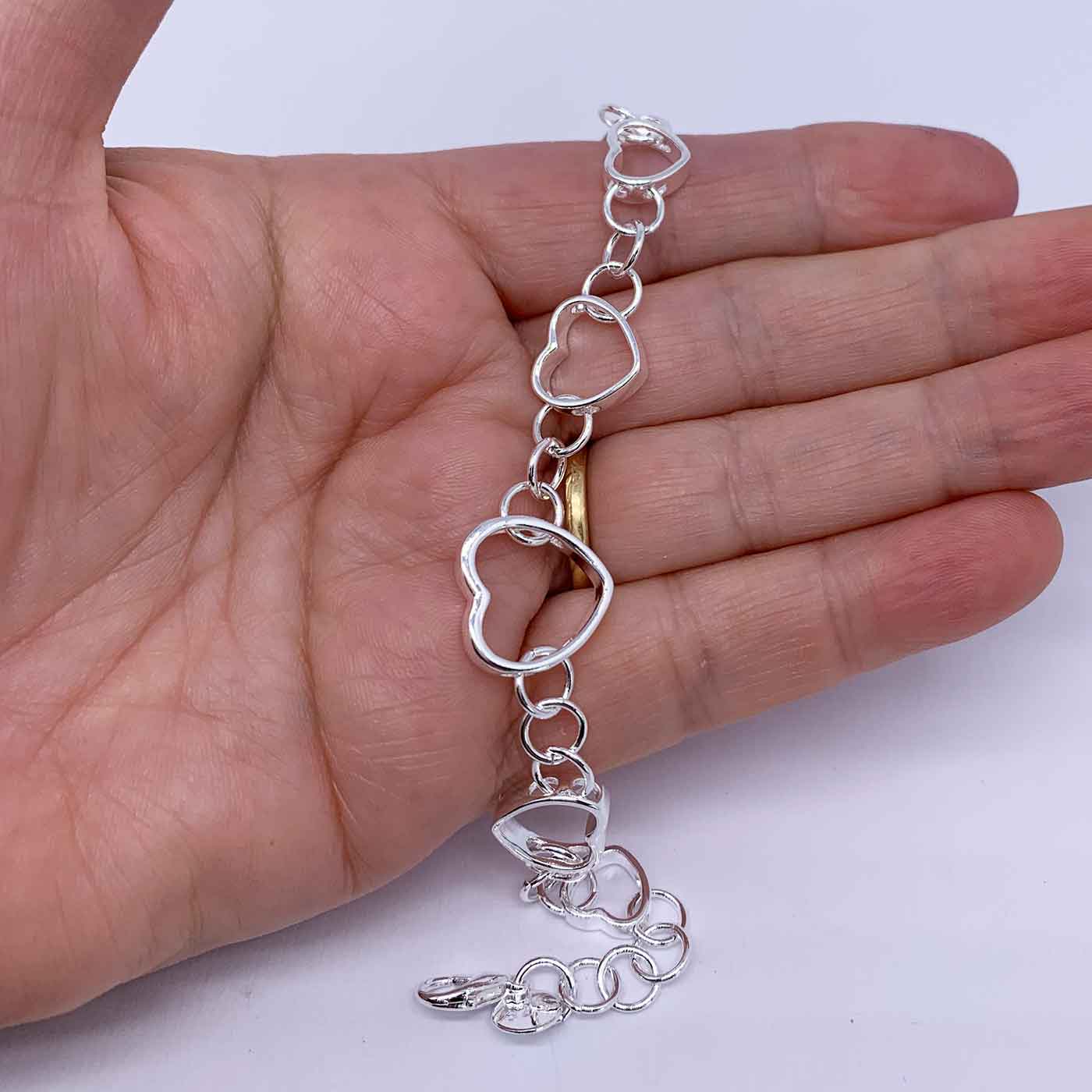1/15 CT. T.W. Diamond Sideways Heart Link Bracelet in Sterling Silver -  7.5