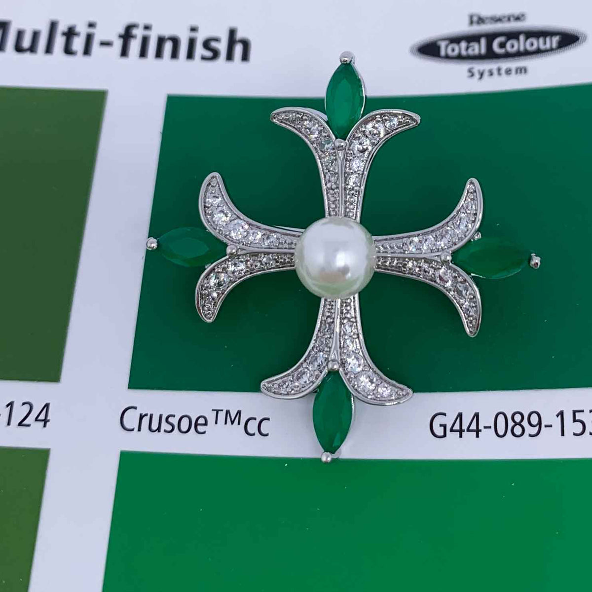 cross shaped brooch green crystals