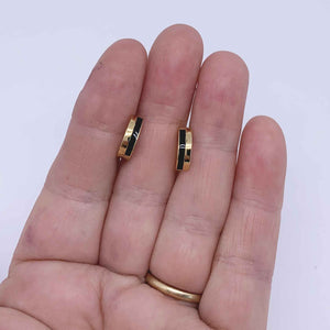gold black huggie earrings hand