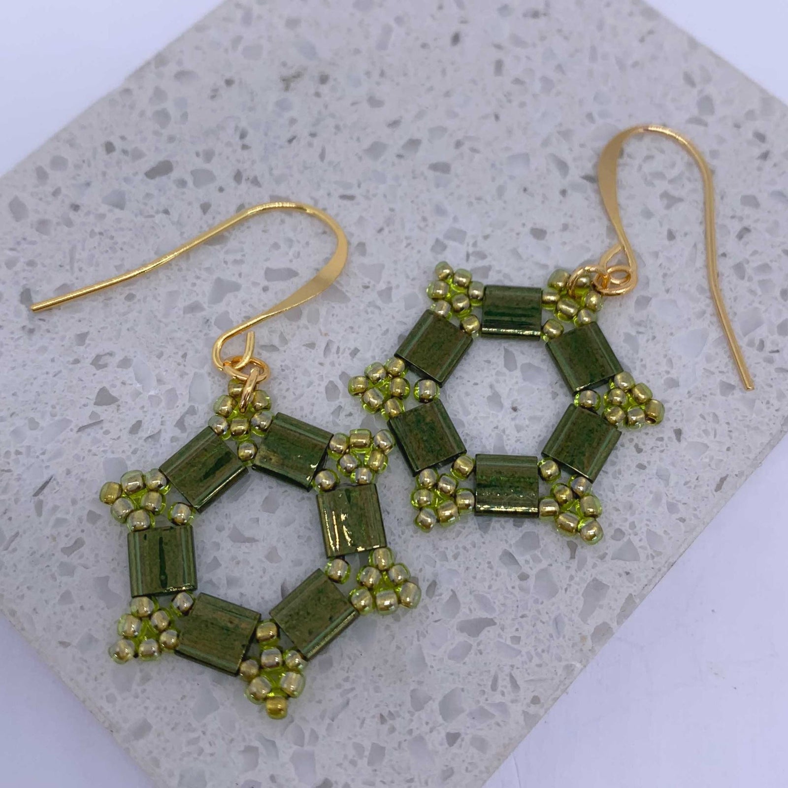 gold dangle earrings green