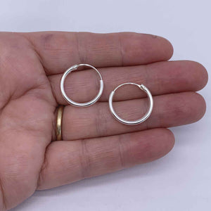 Silver hoop earrings hand