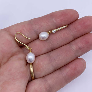 gold pearl drop earrings for bride hand
