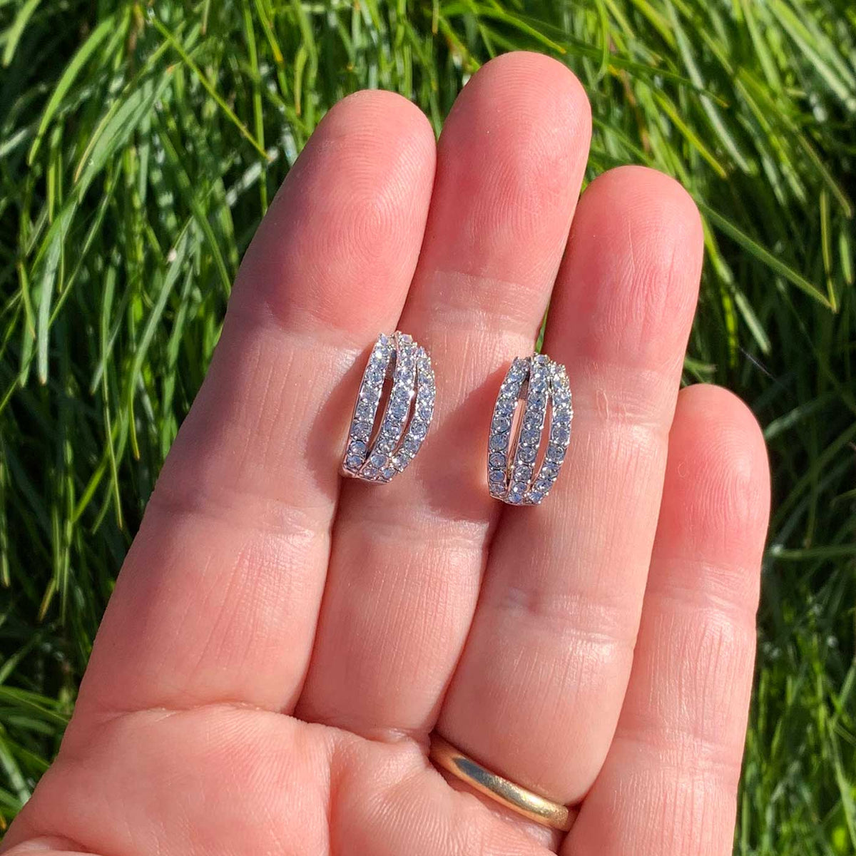 gold huggie earrings hand